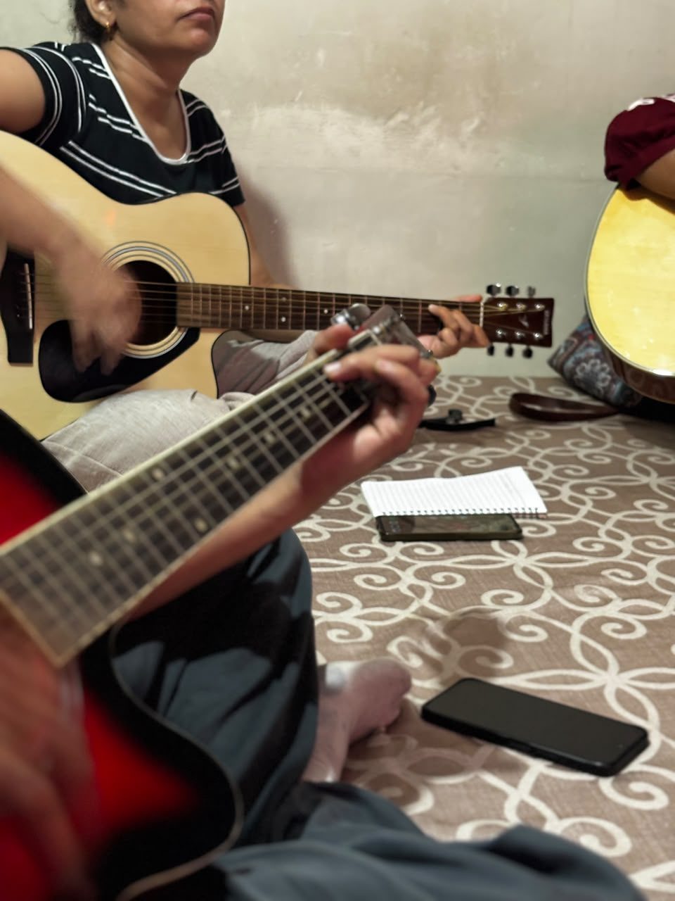 Close-up of a student's hand forming a chord on the guitar fretboard